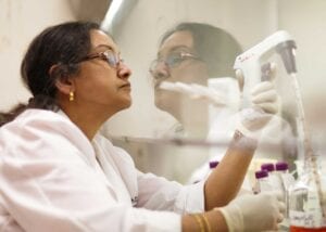 Researcher using lab equipment